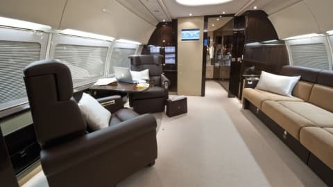Luxury private jet interior with leather seating and cabin amenities