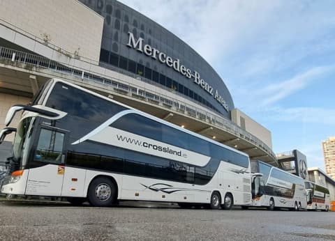 Crossland Bussing tour buses parked outside Mercedes-Benz Arena on European touring production