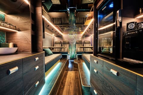 Zeppelin Nightliners luxury nightliner interior with wood veneer bunks teal lighting and premium fit-out