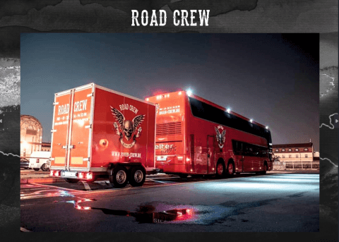 Road Crew Nightliner Service double-decker tour bus and trailer lit up at night on European touring production