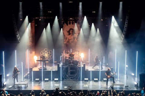 Splendit concert lighting production with moving heads LED totems and beam lights on live stage