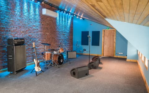Backline equipped rehearsal room at The Loft rehearsal studios Brighton with drum kit guitar amp and bass guitar